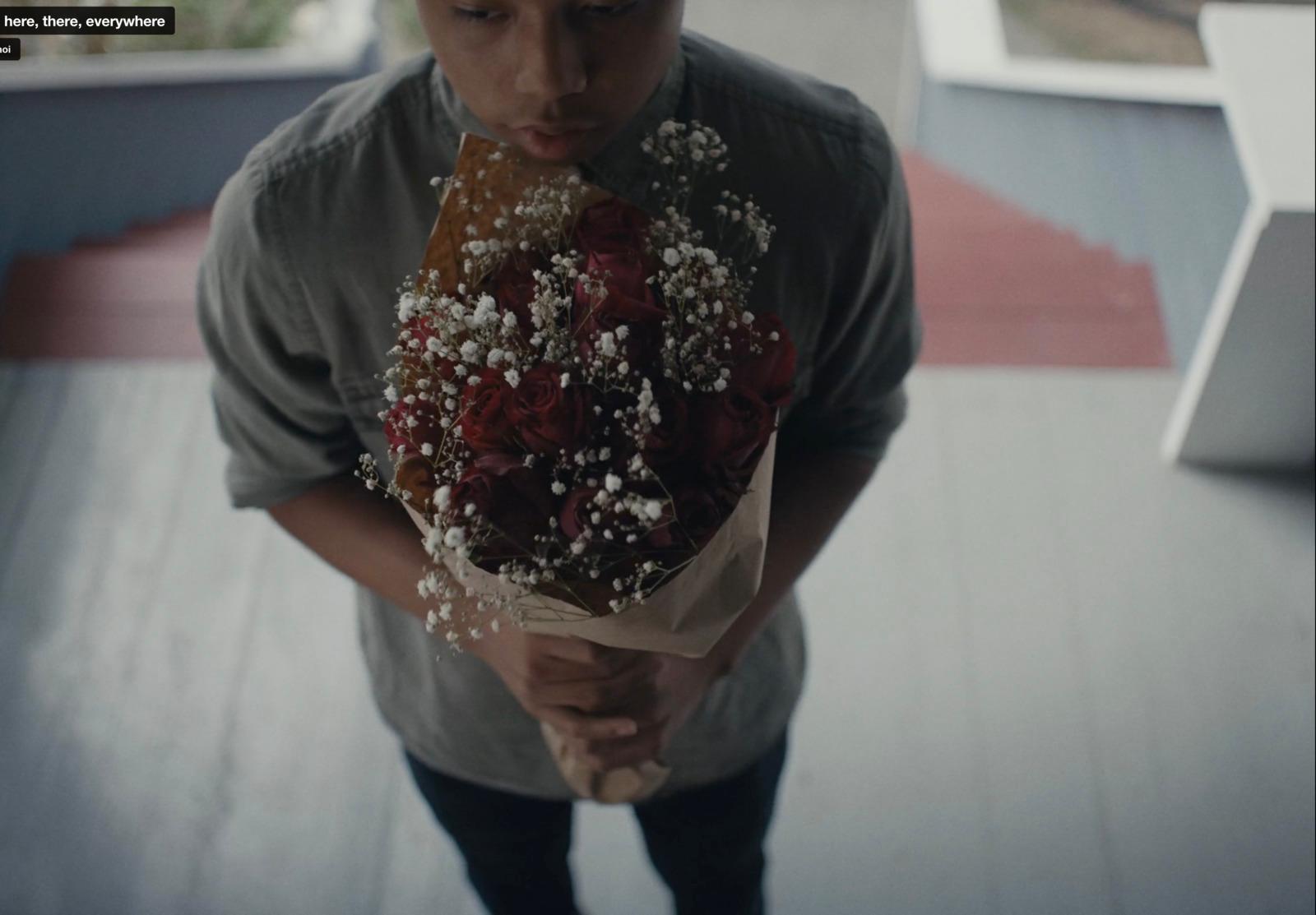 a man holding a bouquet of flowers in his hands