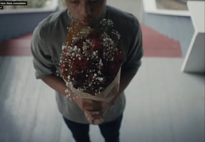 a man holding a bouquet of flowers in his hands
