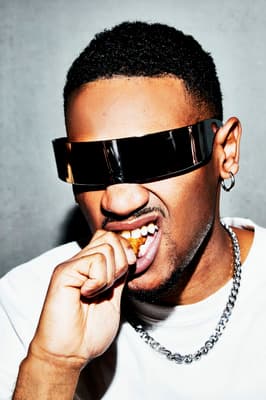 a man with a chain around his neck wearing sunglasses