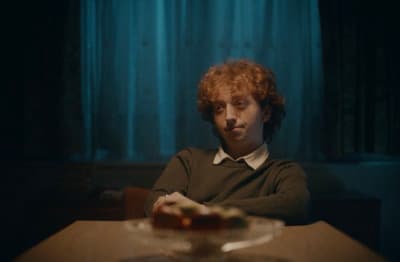 a man sitting at a table in a dark room