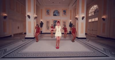 a woman in a white dress standing in a room