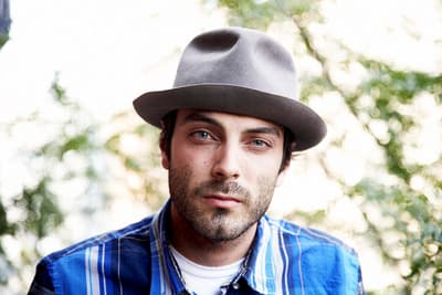 a man wearing a hat and a blue shirt