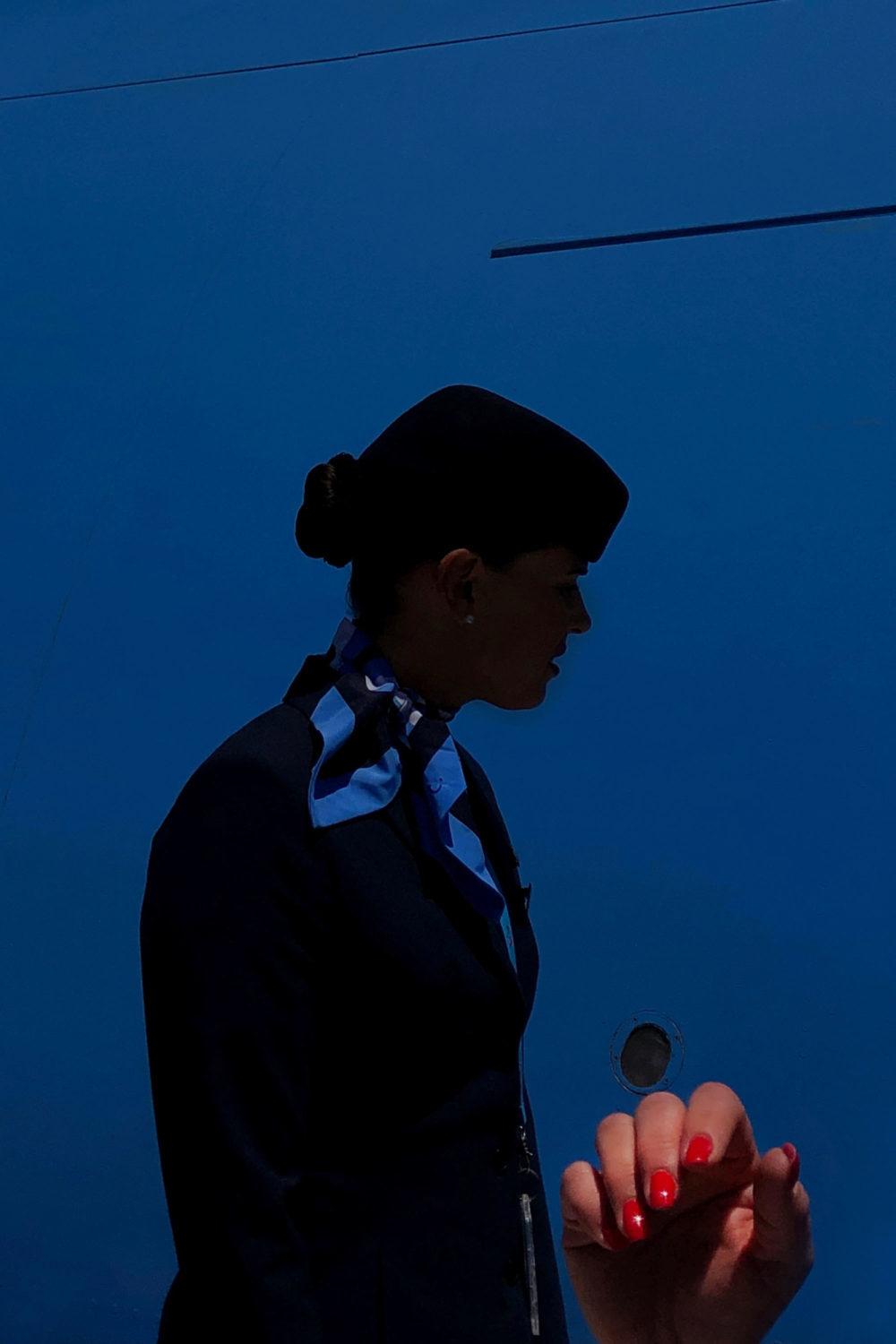 a woman in a business suit holding a cell phone