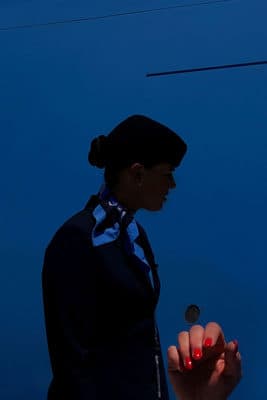 a woman in a business suit holding a cell phone