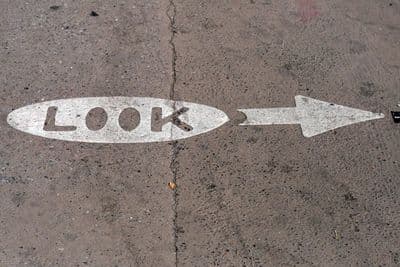 an arrow painted on the ground with the word look painted on it