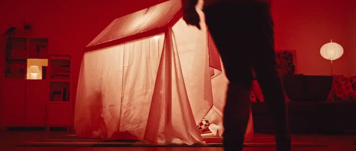 a person standing in a room with a red light