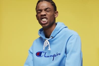 a man in a blue champion hoodie with his mouth open
