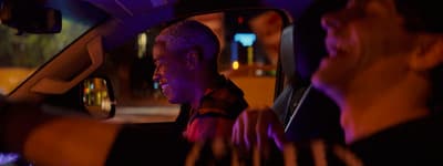 a man sitting in the passenger seat of a car