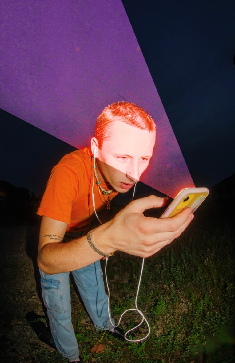 a man with headphones is looking at a tablet