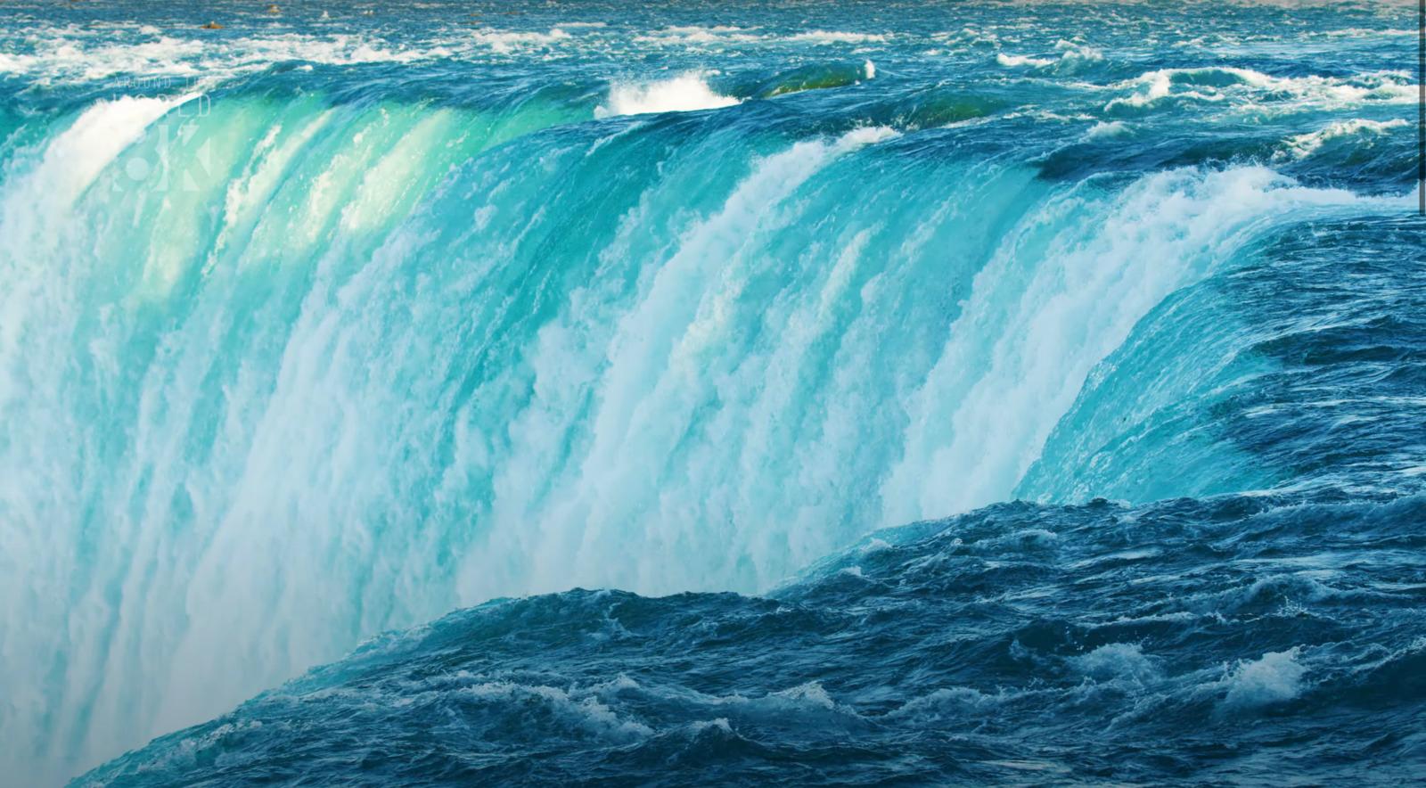 a large waterfall that is in the middle of a body of water