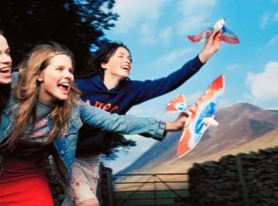 a group of young women playing a game of frisbee