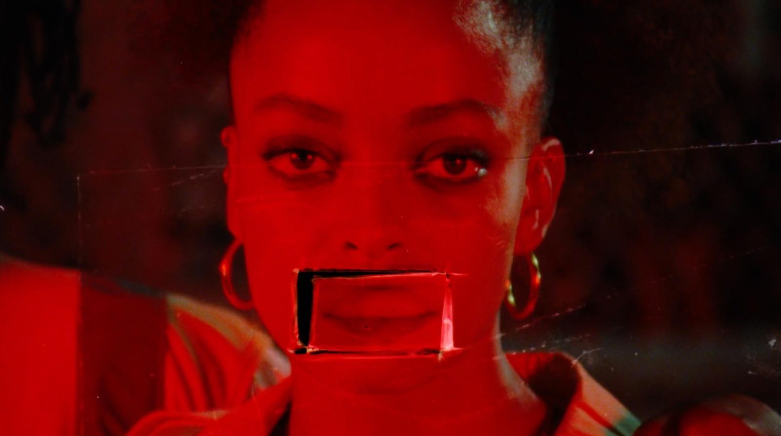 a woman's face is reflected in a mirror
