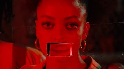 a woman's face is reflected in a mirror
