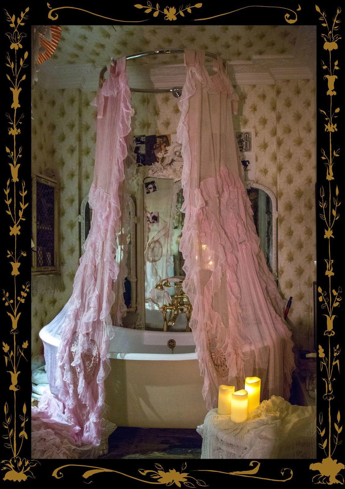 a bath tub sitting next to a candle in a bathroom