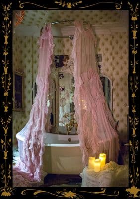 a bath tub sitting next to a candle in a bathroom