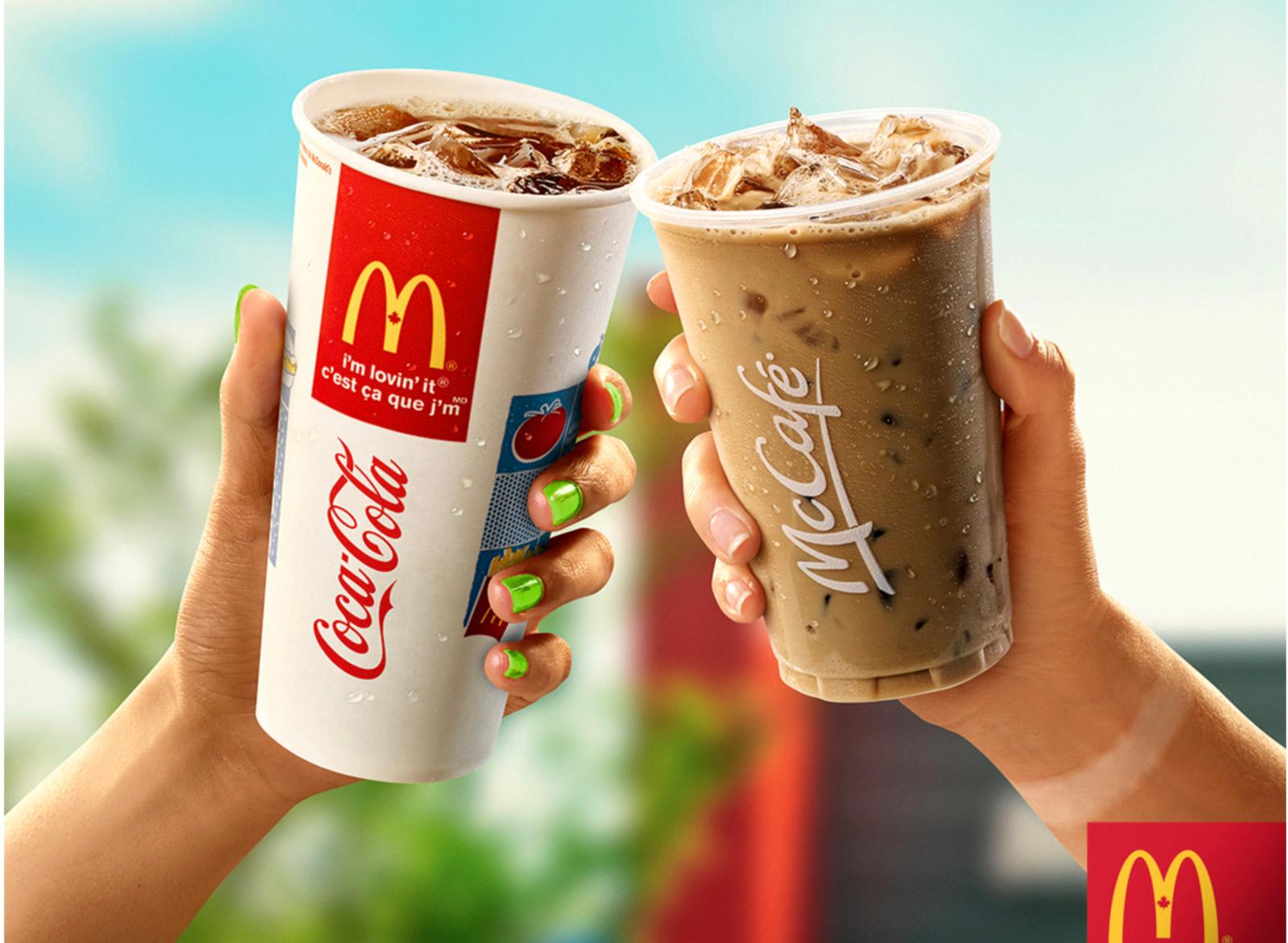 two people holding up drinks in their hands