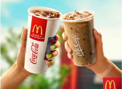 two people holding up drinks in their hands