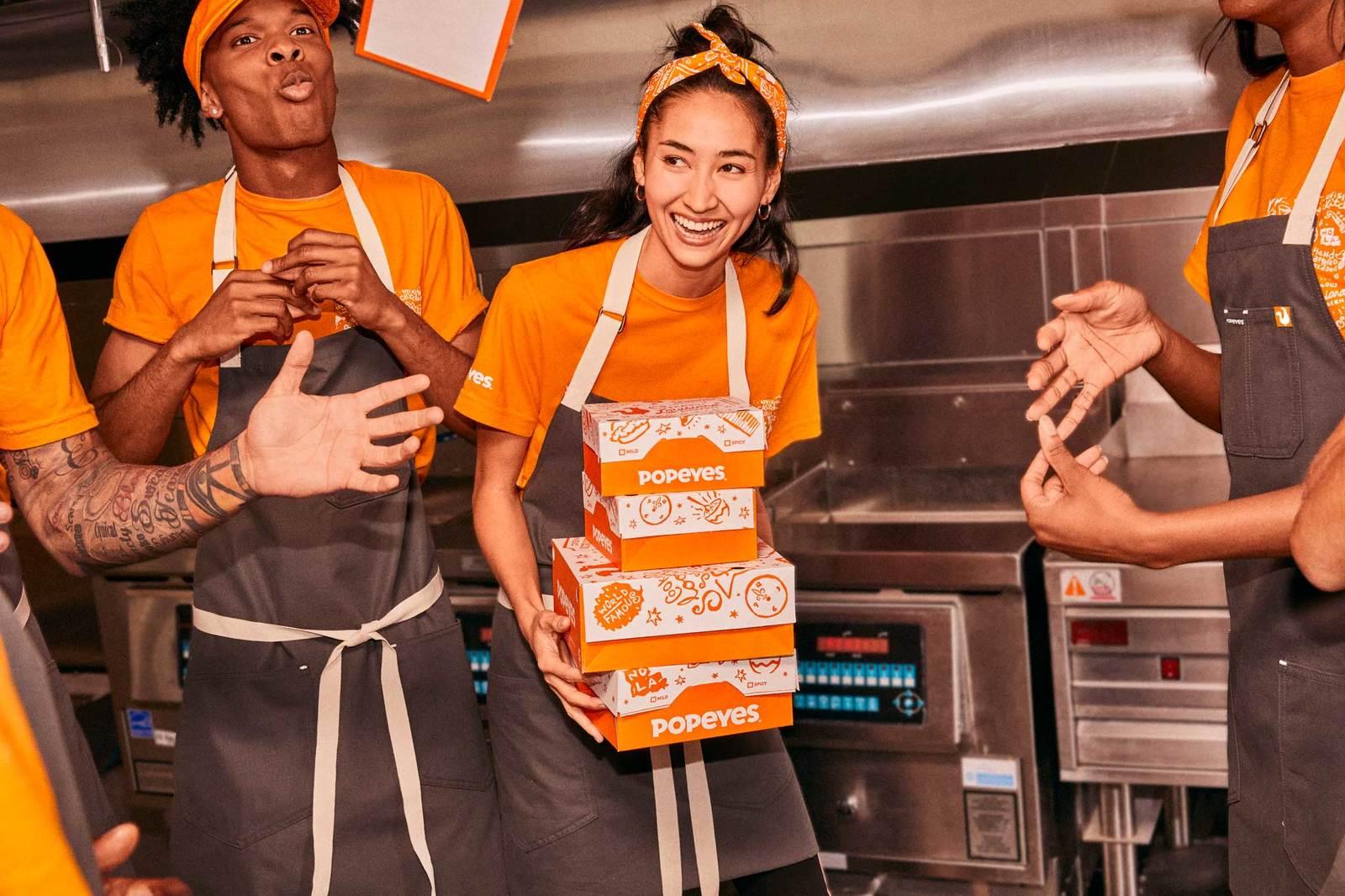 a group of people standing around each other in a kitchen