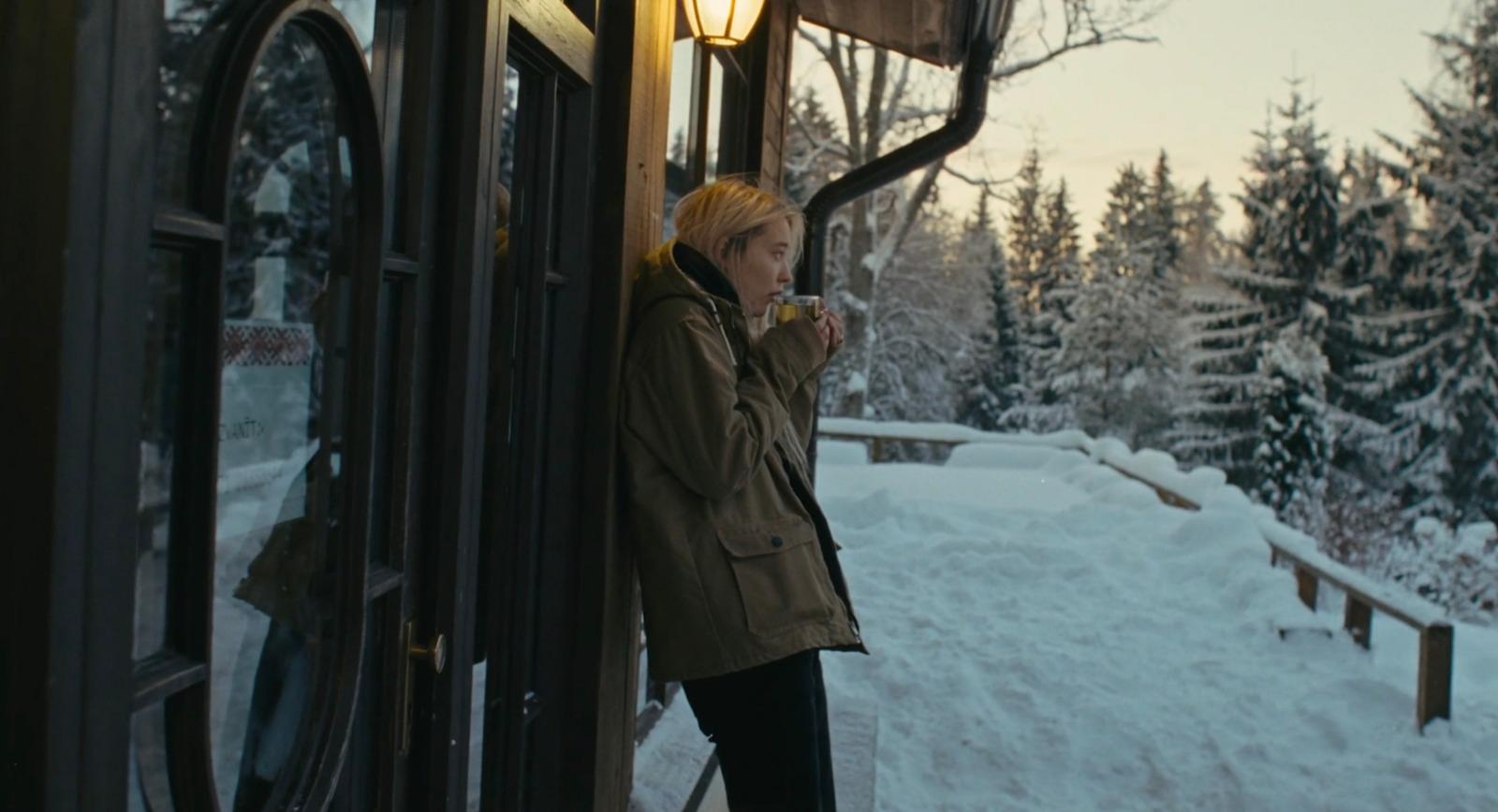 a person standing on a train in the snow