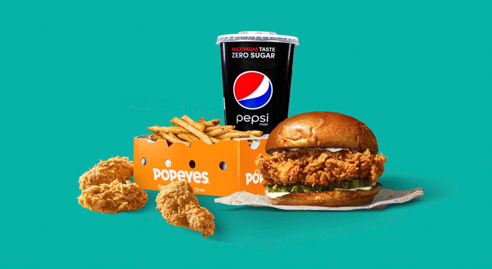 a chicken sandwich with fries and a drink