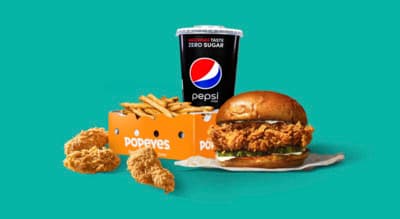 a chicken sandwich with fries and a drink