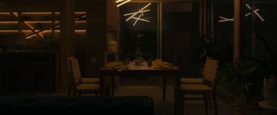 a room with a table, chairs, and a bunch of bananas