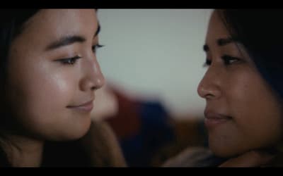 a close up of two women looking at each other