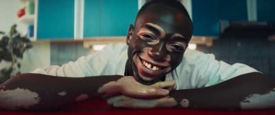 a man with his face painted like a demon