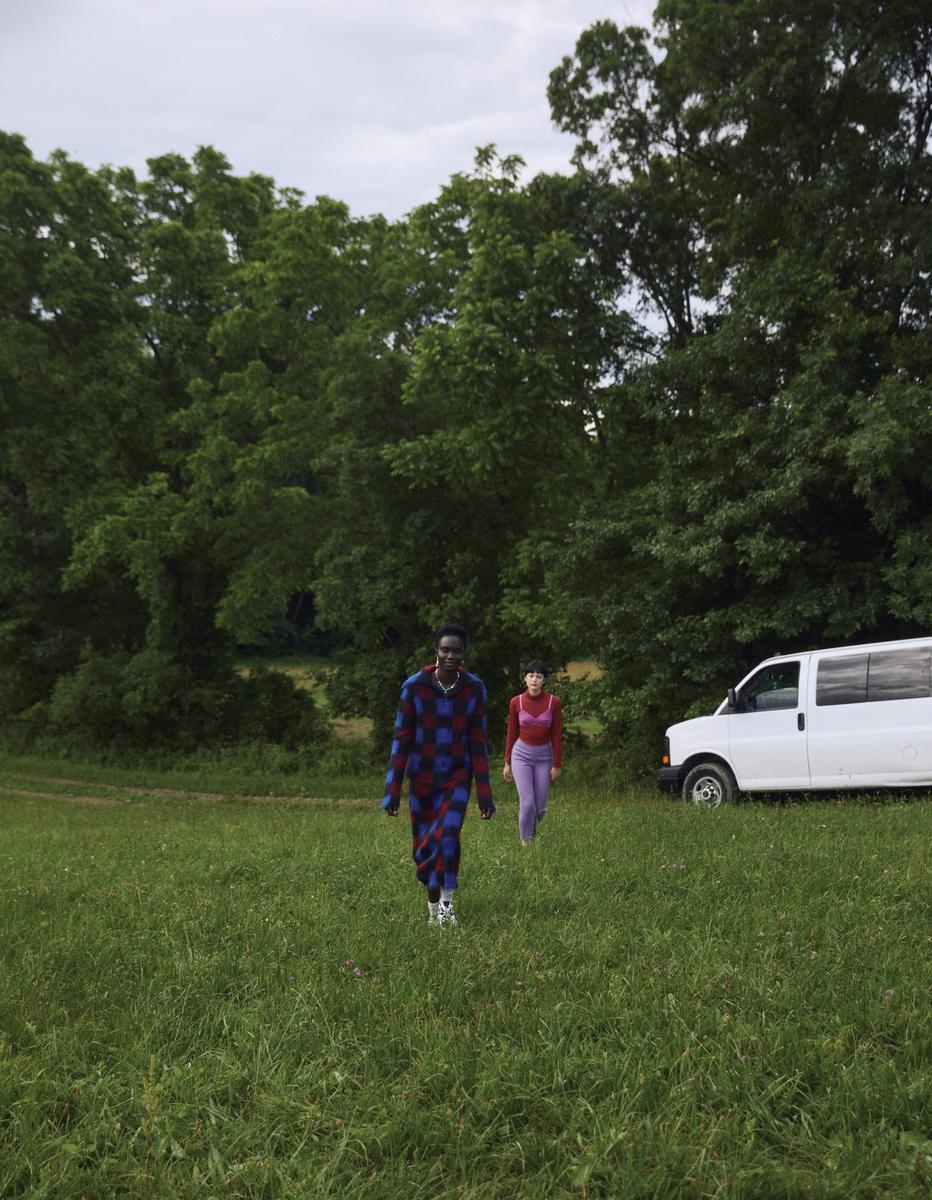 a man and a woman are walking in a field
