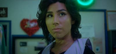 a woman in a room with a green light
