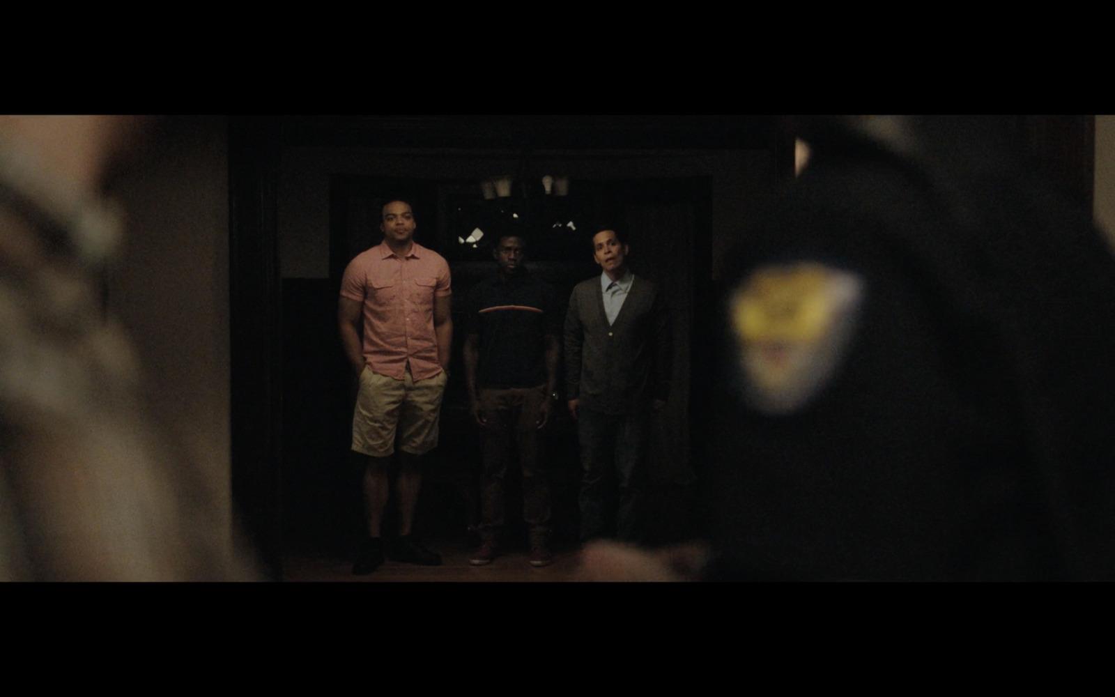 a group of men standing in front of a door