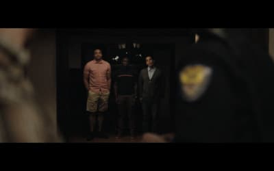 a group of men standing in front of a door
