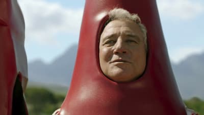 a close up of a person behind a red object