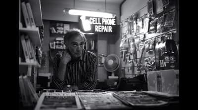 a man sitting at a desk in a store