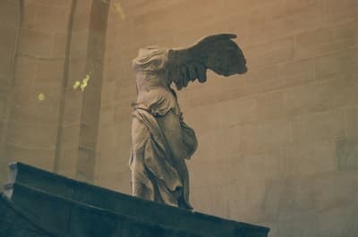 a statue of an angel on top of a building