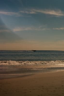 a view of a beach with a boat in the water