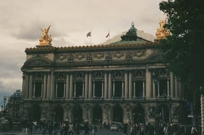 a large building with many people walking around it