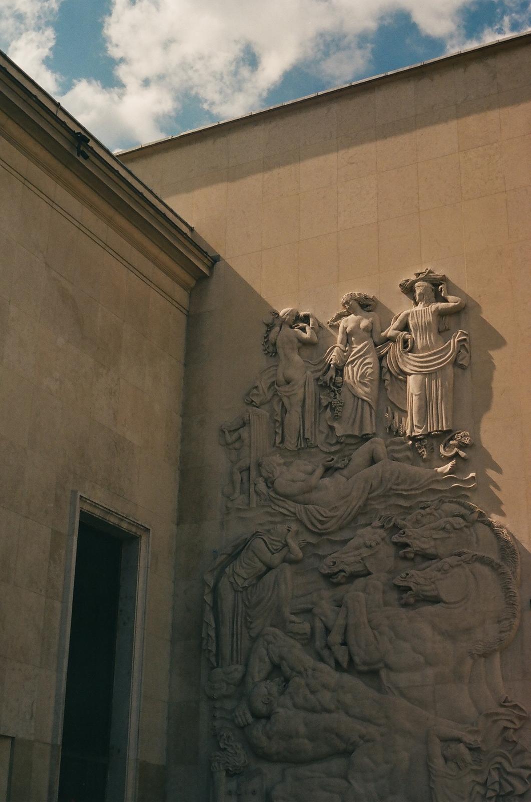 a clock on the side of a building with a sky in the background