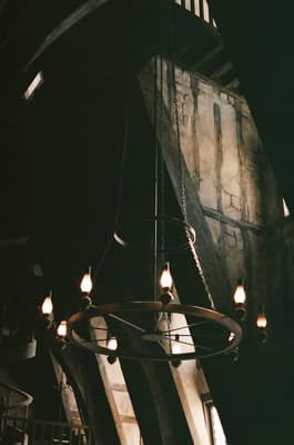a clock hanging from the ceiling of a building