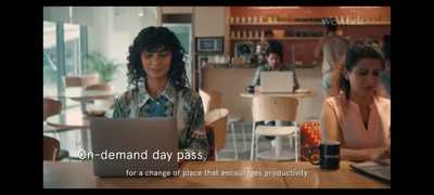 two women sitting at a table with a laptop