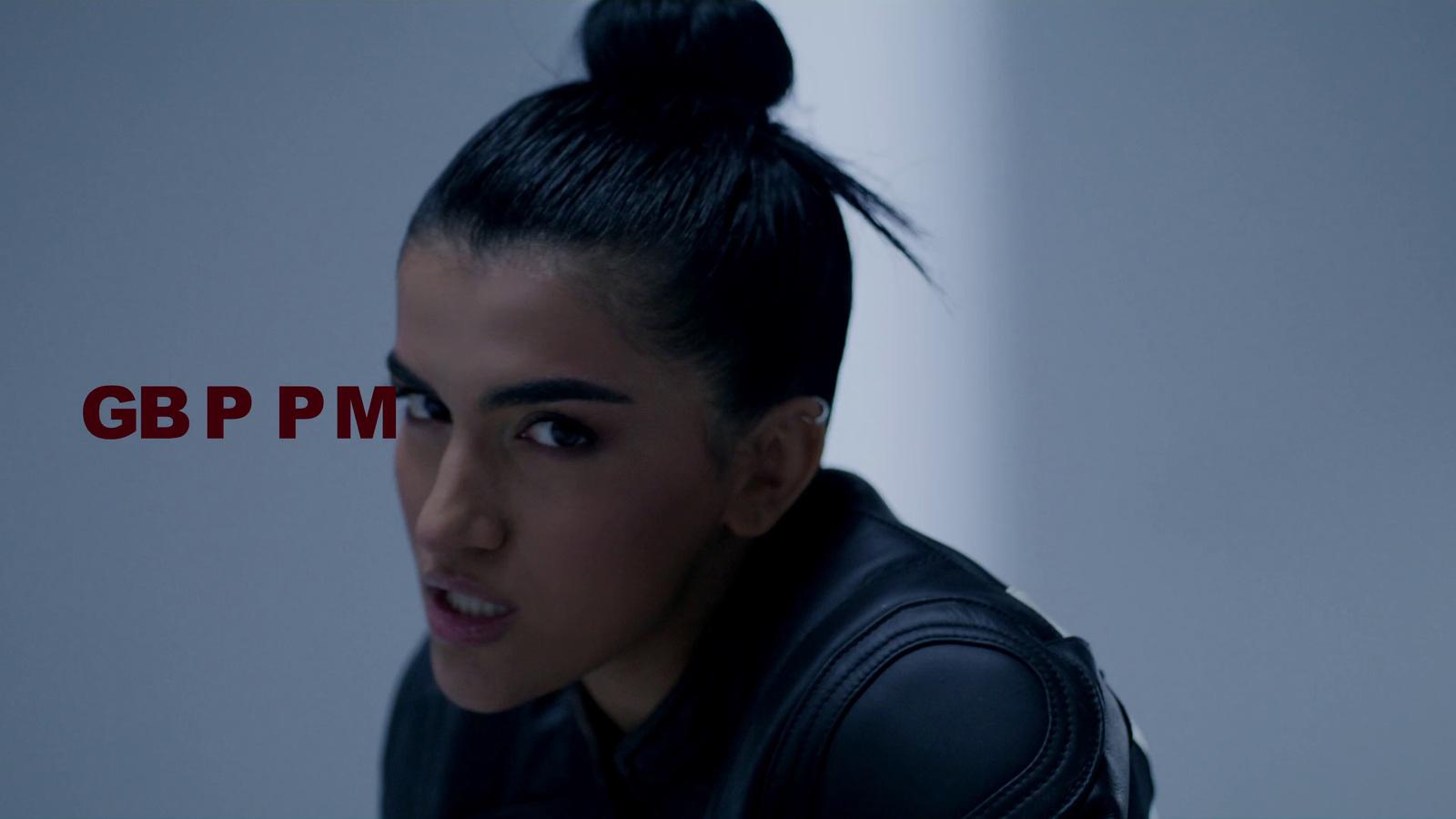 a woman with black hair and a black jacket