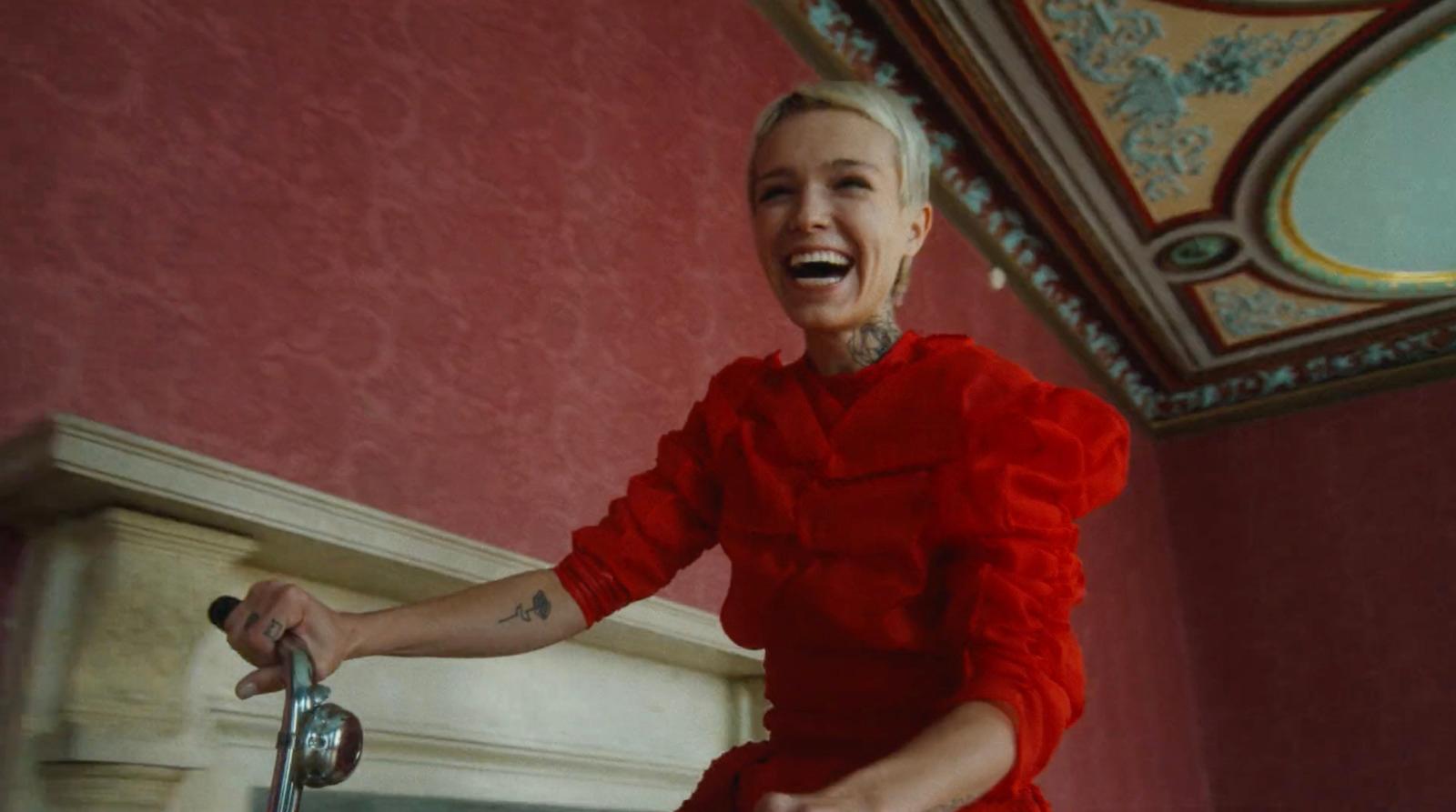 a woman in a red dress is laughing