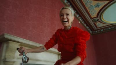 a woman in a red dress is laughing