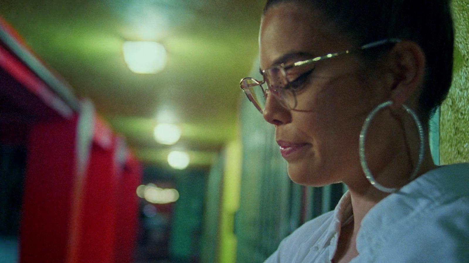 a woman in glasses looking at her cell phone