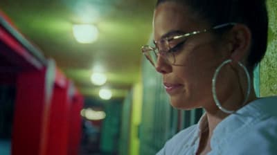 a woman in glasses looking at her cell phone