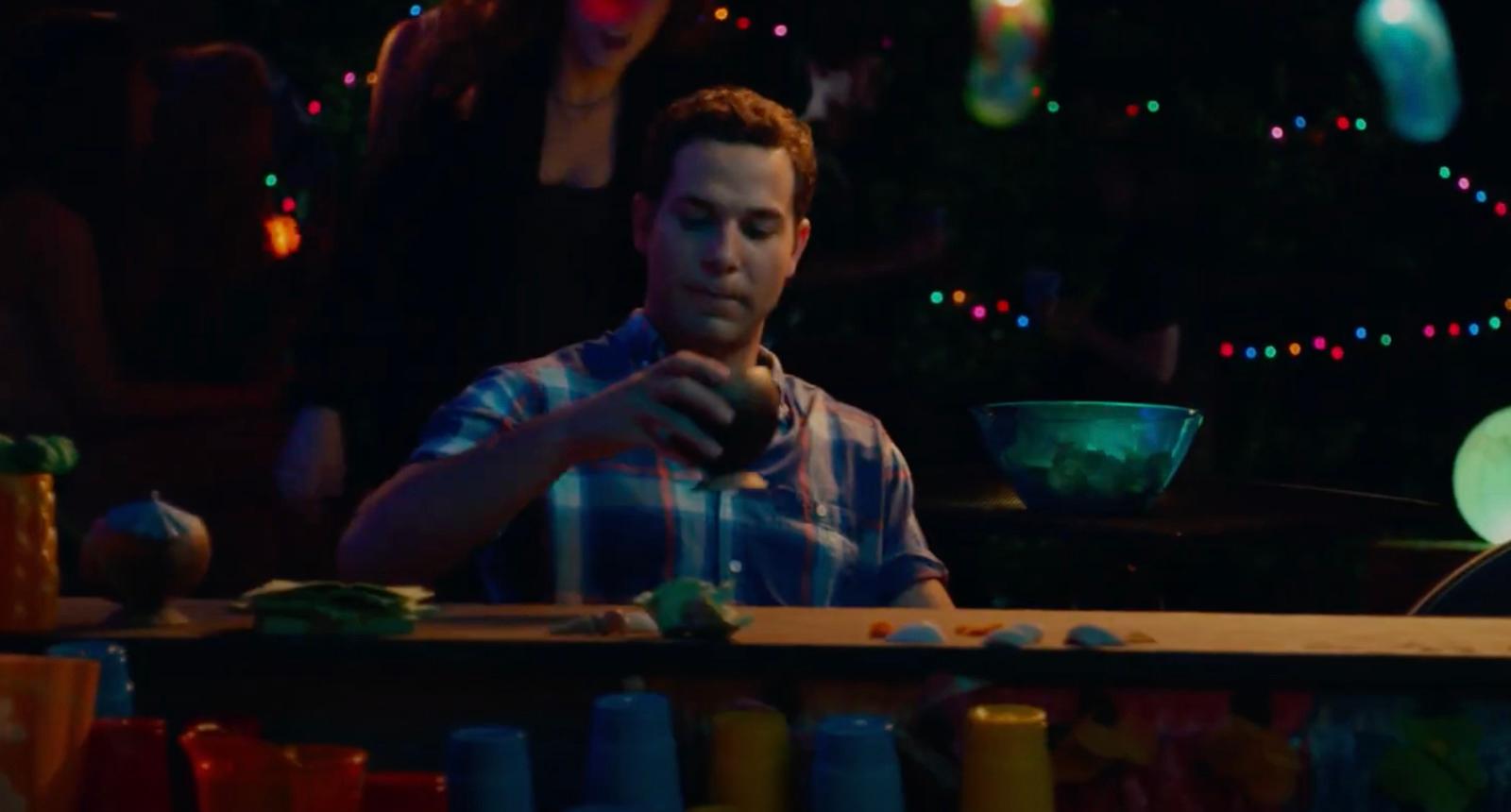 a man sitting at a table in front of a bowl of food