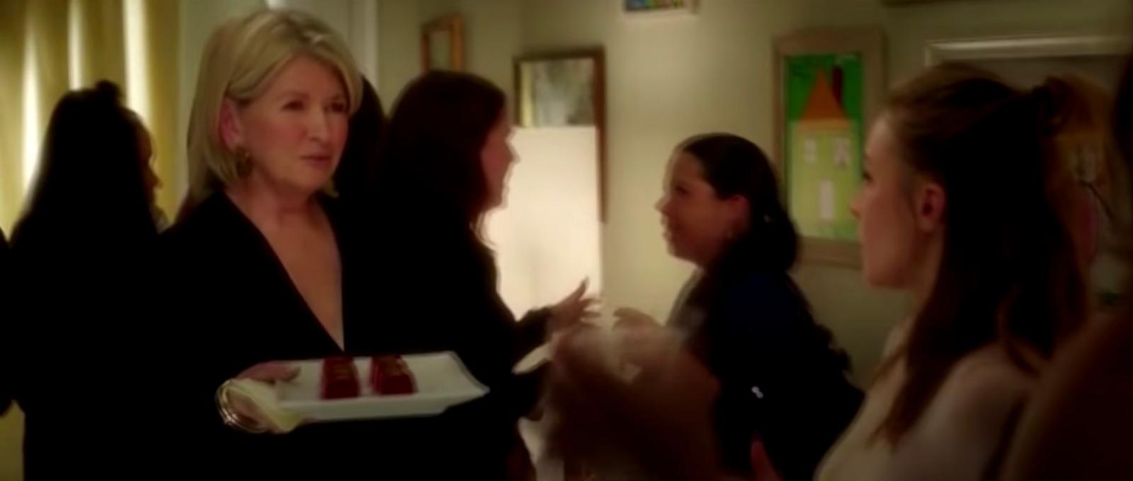 a woman holding a plate of food in a room