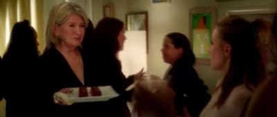 a woman holding a plate of food in a room