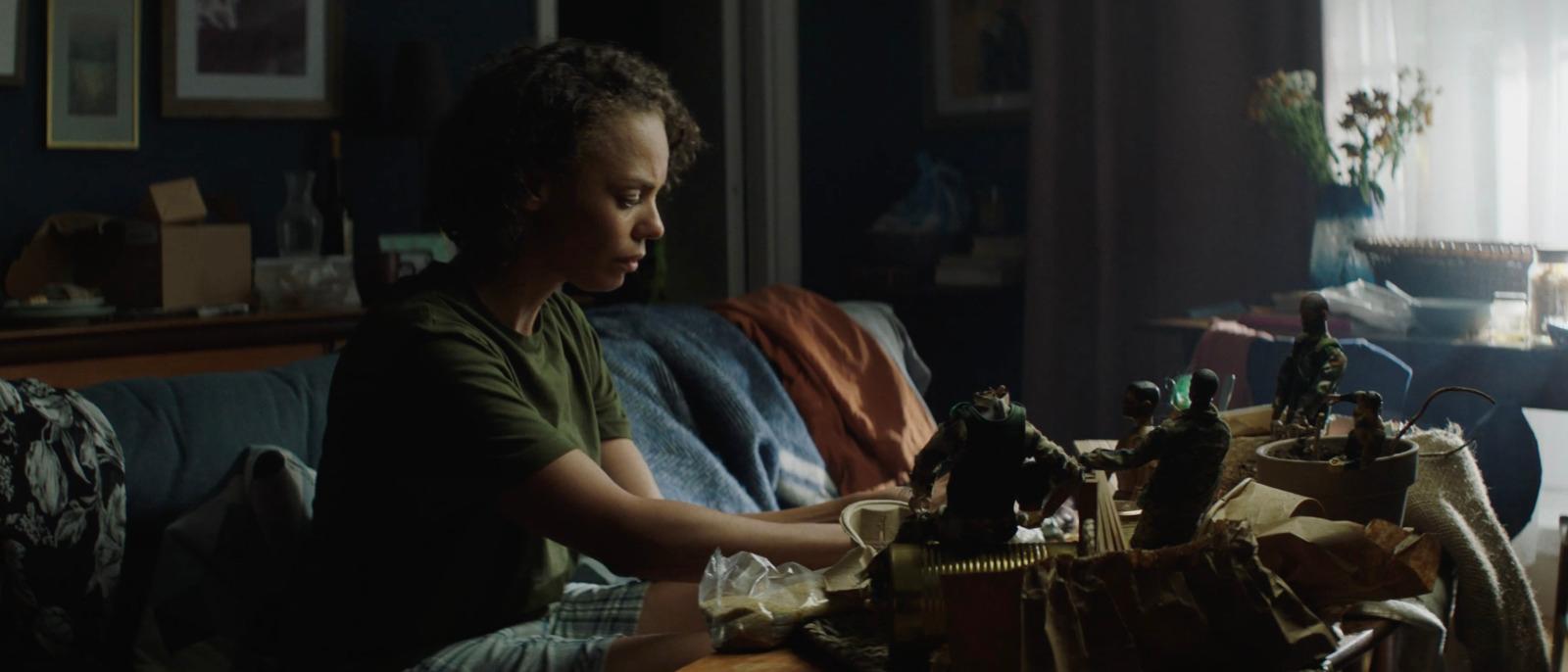 a young boy sitting on a couch in a living room