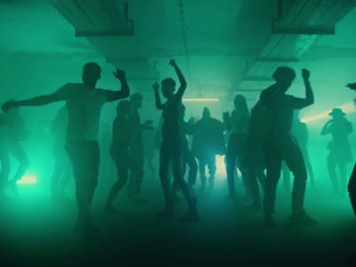 a group of people dancing in a dark room